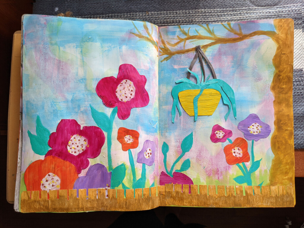 Image of a page in my art journal of big bright flowers, a tree, a fence and a hanging flower pot