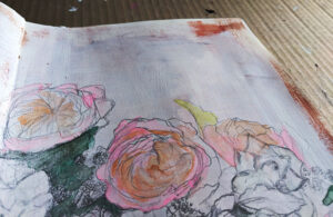 Close up of art journal - sketched flowers, painted pink with white background
