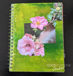 Cover of art journal - dark green background with two pink flowers