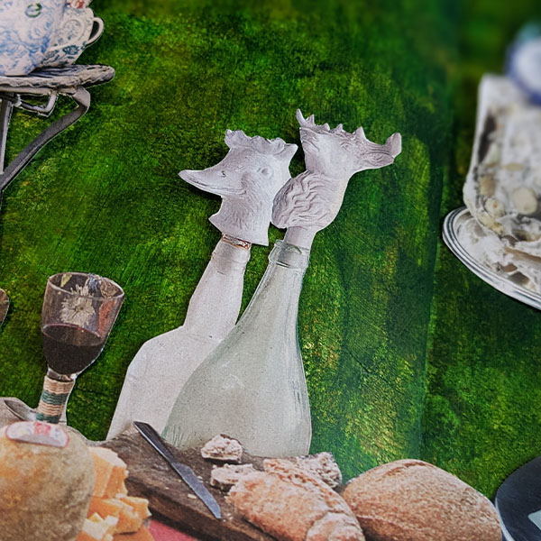 Close up of collage elements, white bottles in the shape of animals on a dark green background