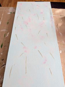 Image of the painting I painted over which has a very pale blue background, pale pink flowers and brown stems