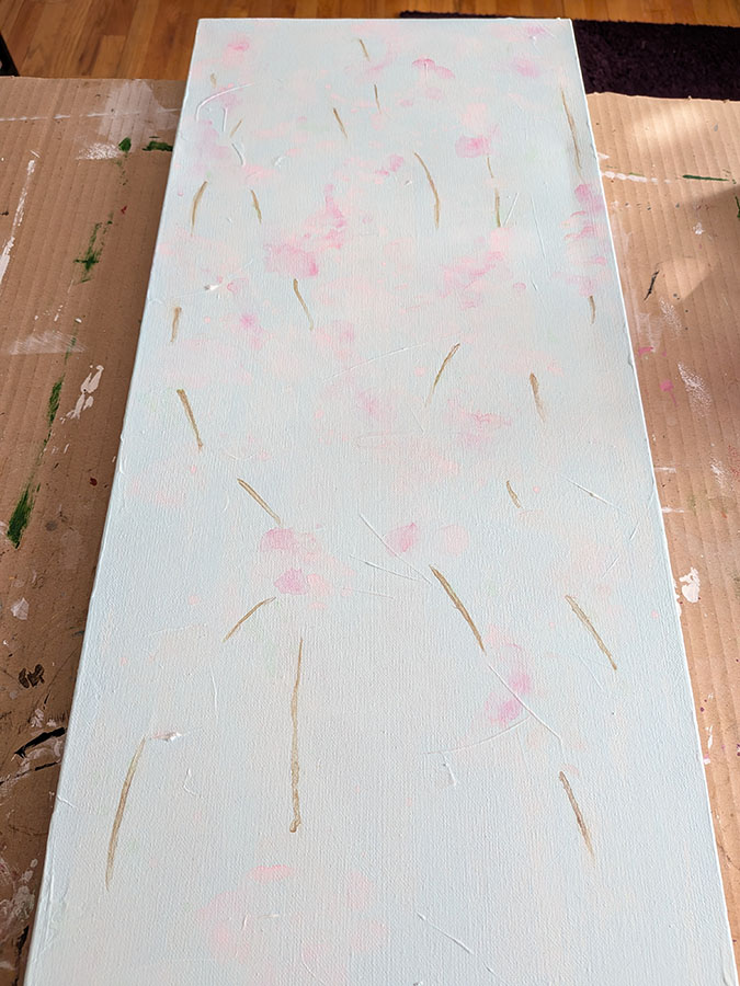 Image of the painting I painted over which has a very pale blue background, pale pink flowers and brown stems